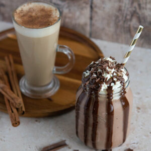 Iced chocolate frappe and flavoured latte on a tray