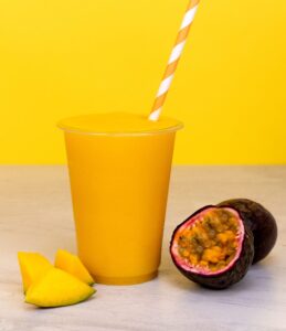 Mango and passionfruit smoothie. healthy breakfast idea. fresh fruit drink, cold summer beverage